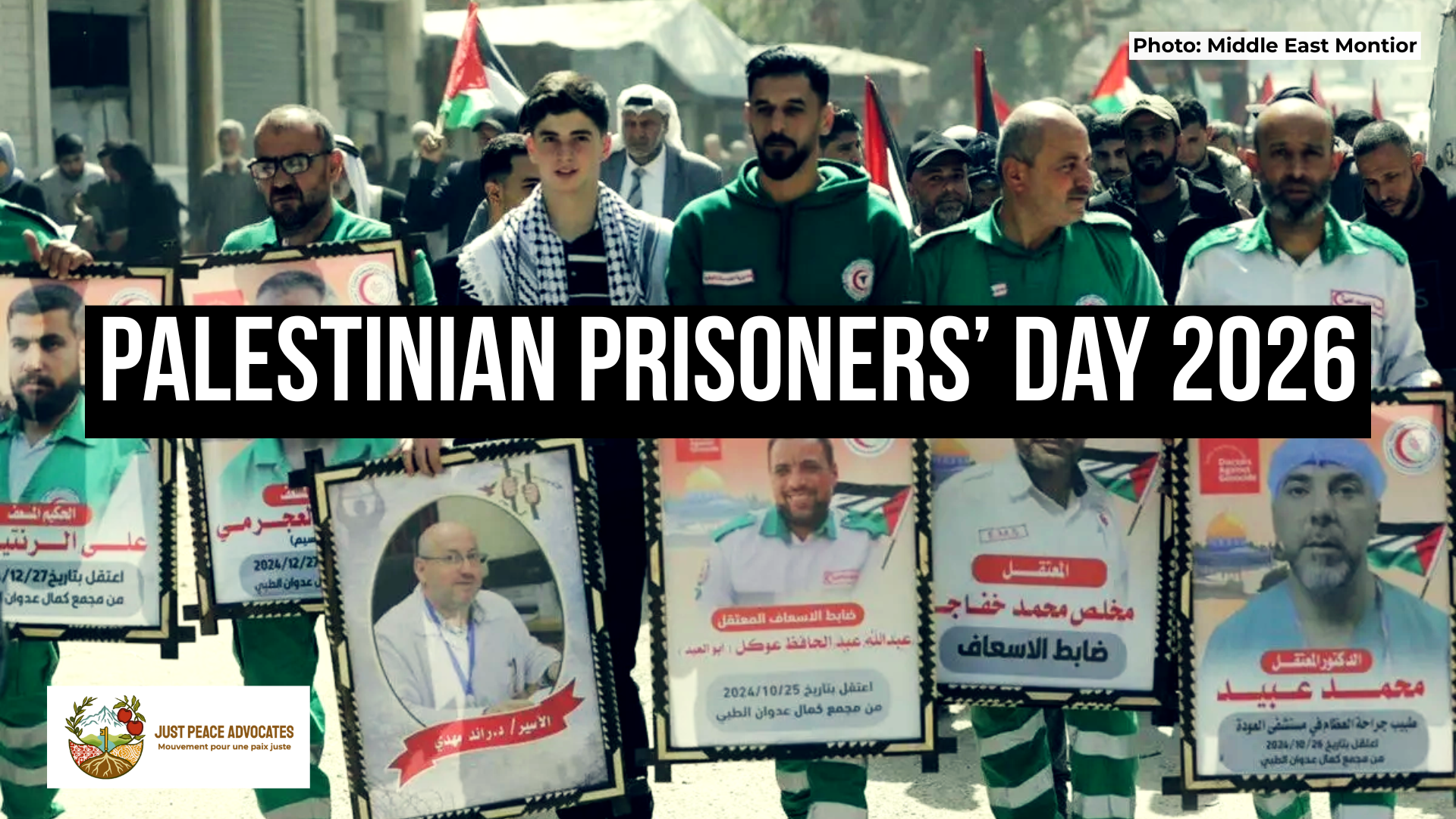 Background image of a group of individuals, mostly Palestine Red Crescent Society workers, holding signs showing their colleagues who are imprisoned or forcibly displaced by Israel. This was part of protests in Gaza City in support of Palestinian Prisoners' Day 2026. Text reads: Palestinian Prisoners’ Day 2026