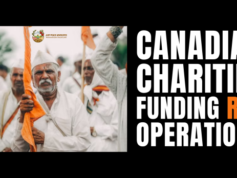 Black background with a photo a group of Indian men with brown skin, wearing white clothes and hats, holding bright orange flags. The orange or saffron flags are the official symbol of the RSS. Text reads: Canadian charities funding RSS operations.